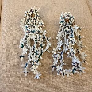 Fun white dangle post earrings with a touch of blue beads.